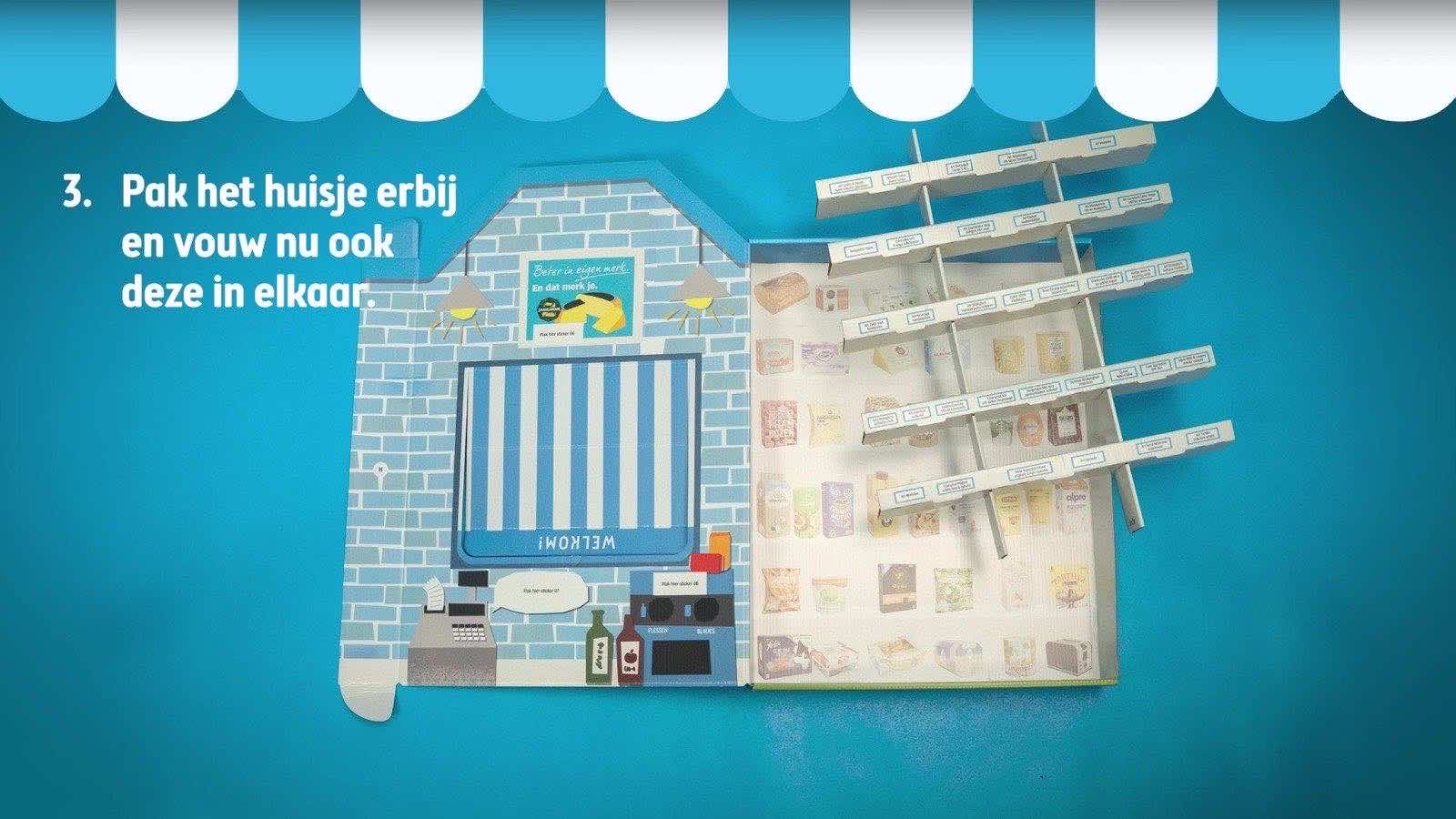 A pop-up cardboard toy supermarket with shelves and a checkout, built for the Albert Heijn films.