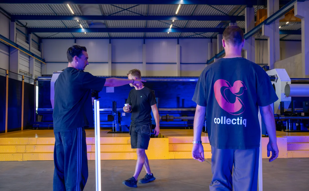 Crew setting up on a blue-lit indoor set