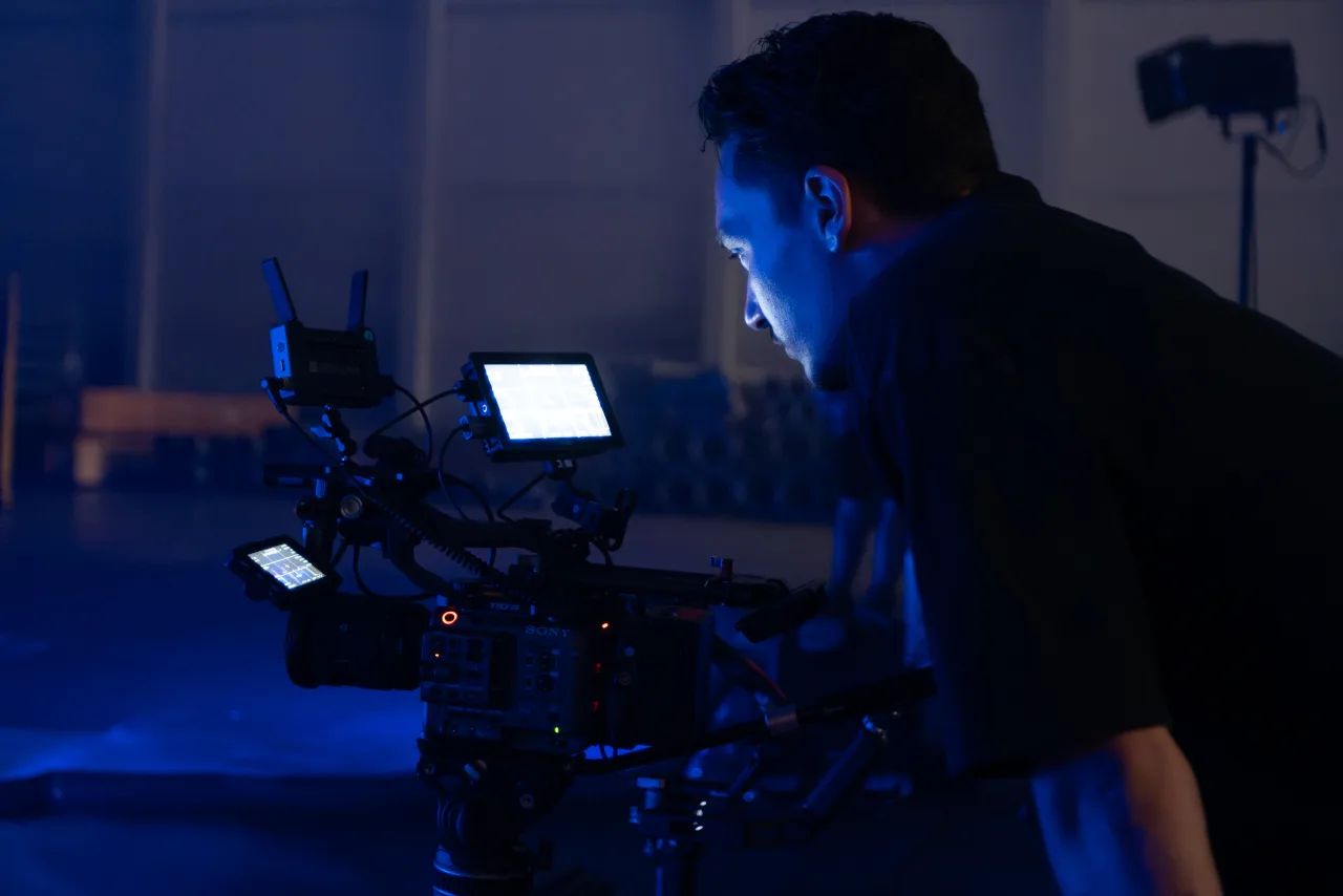 An operator working behind a camera rig on set