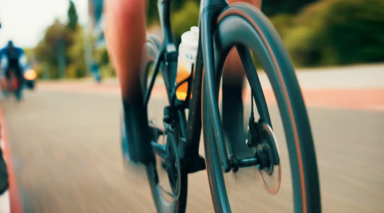 A low, close shot of a road bike in motion