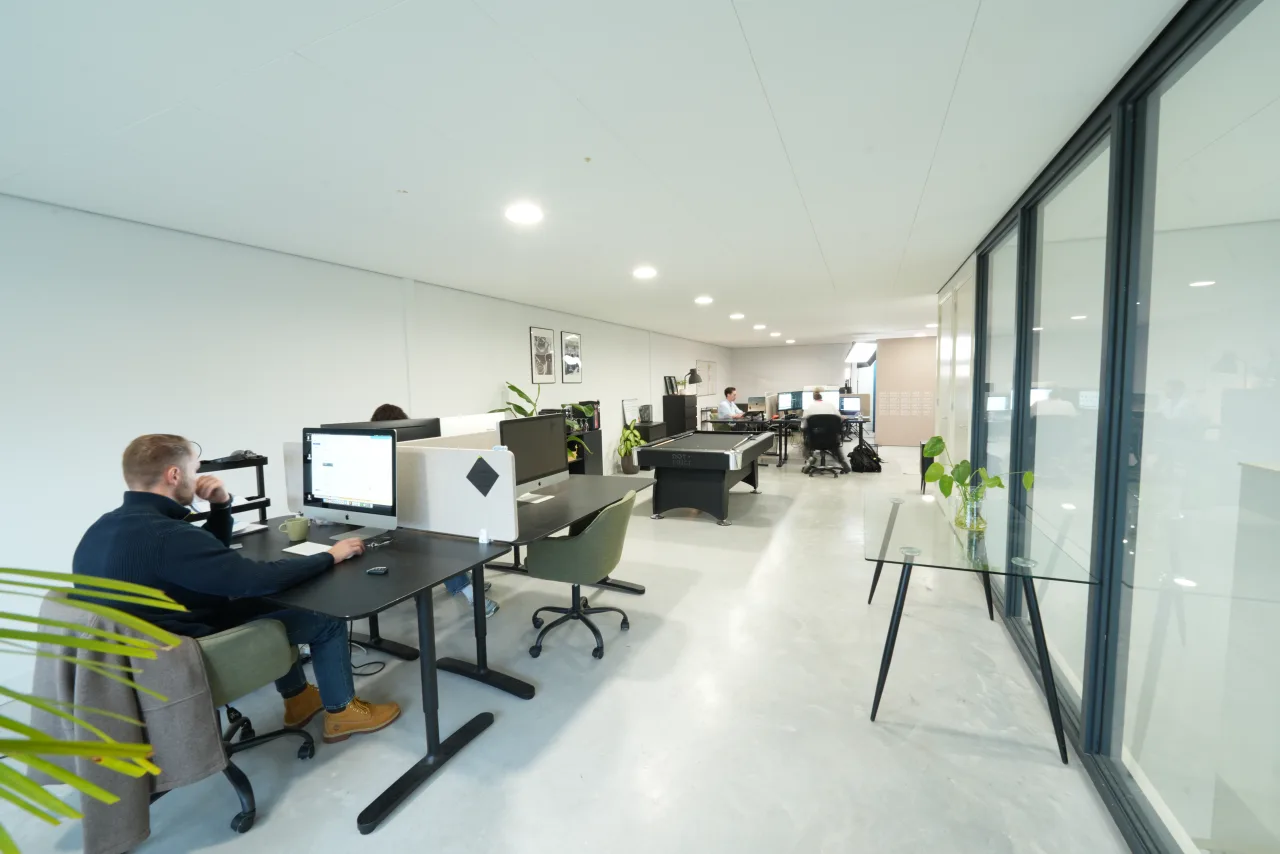 An open-plan office with someone working at a desk