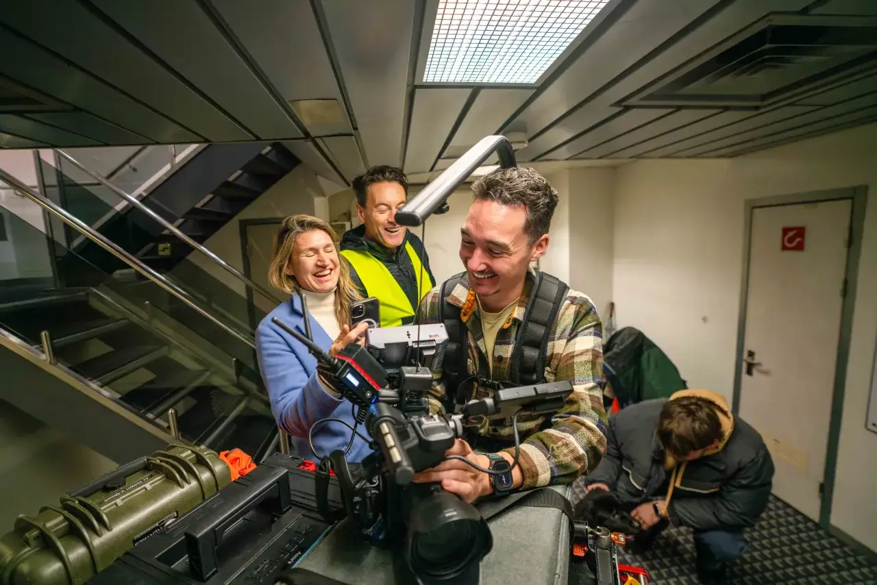 Crew carrying camera equipment on location